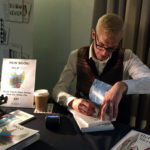 Mark Hill signing Czech glass books at the Cambridge Glass Fair